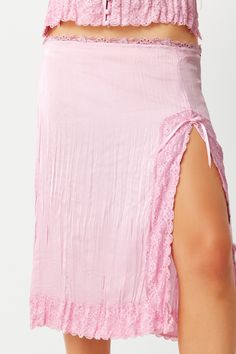 Slip into the embrace of our Countryside midi skirt. This midi skirt is designed in a crinkle satin fabric with a flattering front leg slit, ribbon detail & floral lace trim. Complete the set with the matching Besos camisole. Fabric Self: 100% Polyester Crinkled Satin Model Size & Fit This style runs true to si