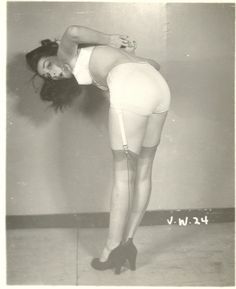 an old black and white photo of a woman in stockings